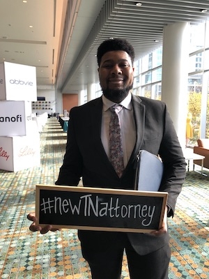 New lawyer Joshua McSwain celebrates after taking the oath