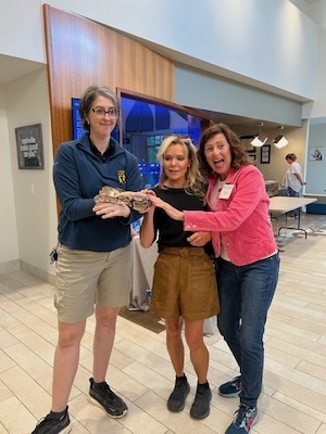 Zoo employee shows a python to program attendees